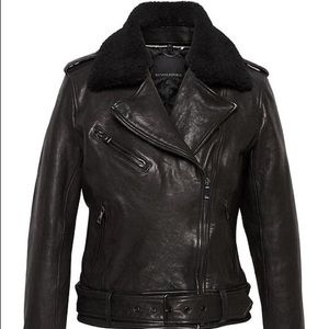 LIKE NEW Black leather jacket with belt and  shearling collar.
